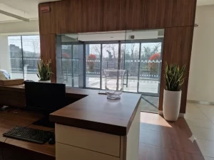 Un ingresso elegante di una show room di autovetture realizzato con una bussola dotata di porta automatica scorrevole con due ante fisse e due ante mobili.